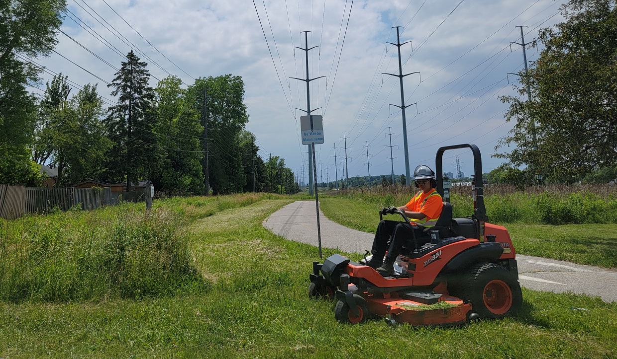 TRCA restoration team member conducts turfgrass buffer mowing in The Meadoway