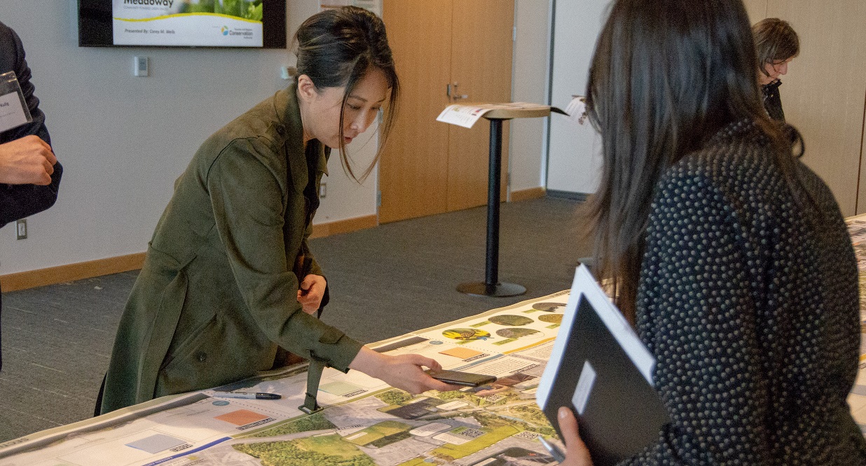 community members examine Meadoway map at public information centre