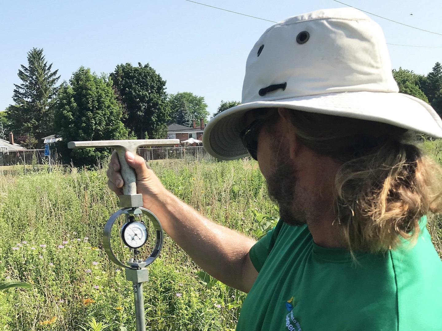 TRCA restoration team member helps to conduct infilatration rate research in The Meadoway