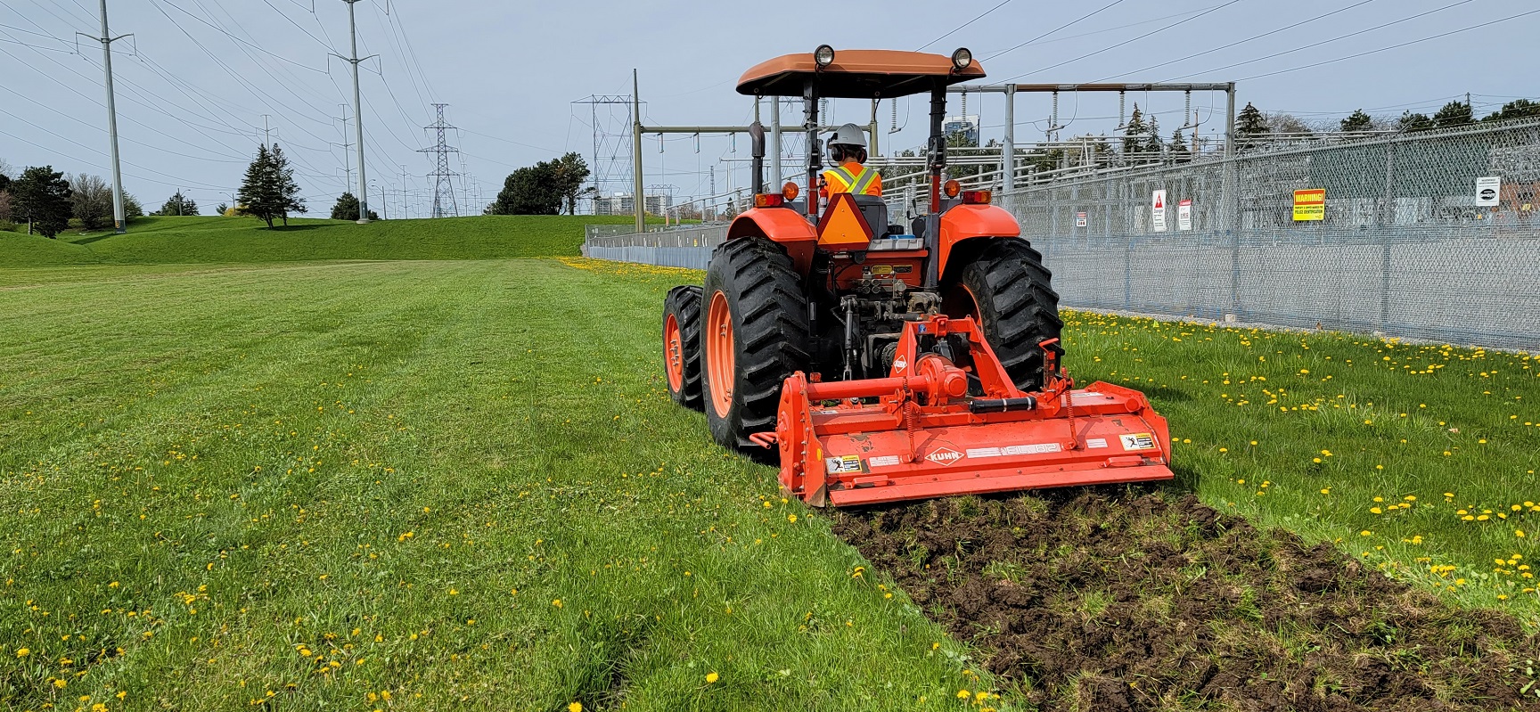 TRCA Meadoway restoration staff rototilling the turfgrass to help remove invasive species and prepare the soil for native seeding