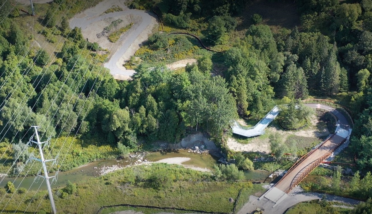 aeriel view of a permanent bridge allowing Meadoway trail users to cross the East Highland Creek
